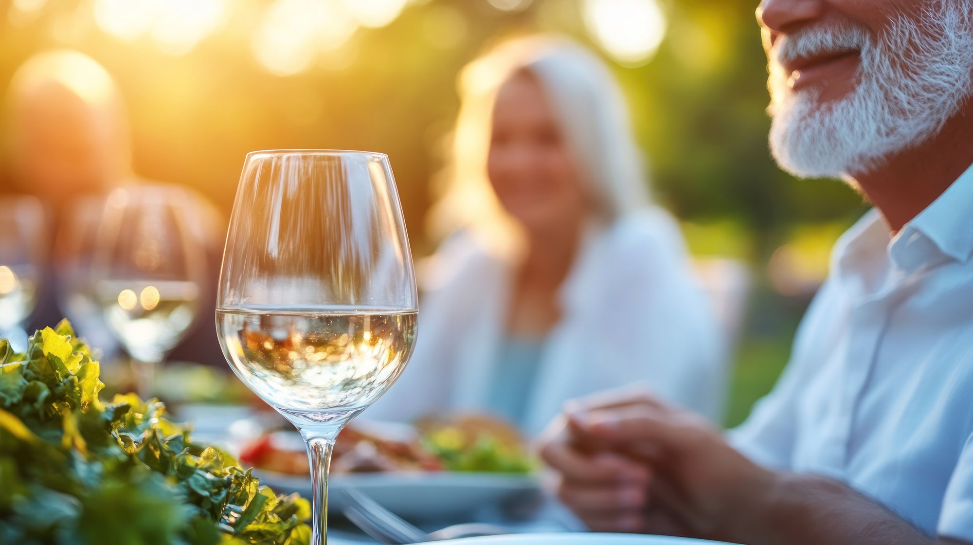 People eating food and drinking wine